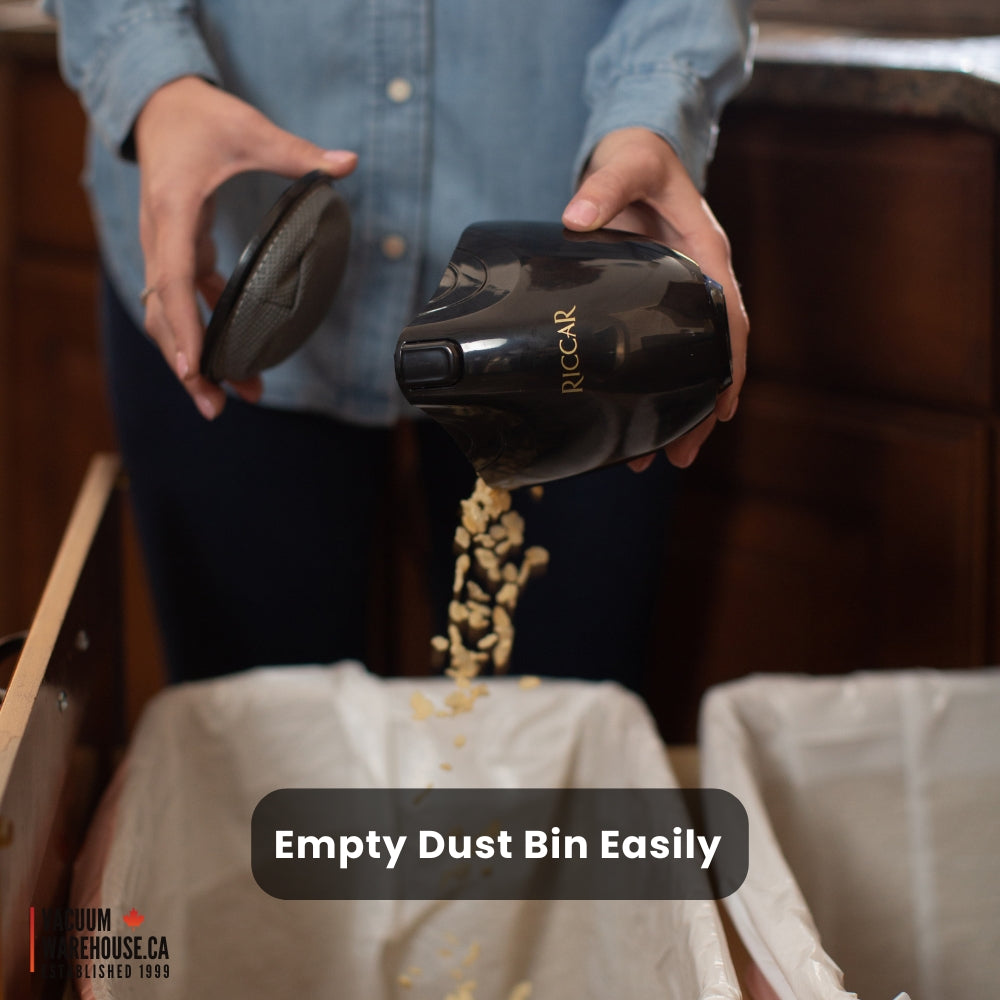 emptying Riccar gem handeled vacuum